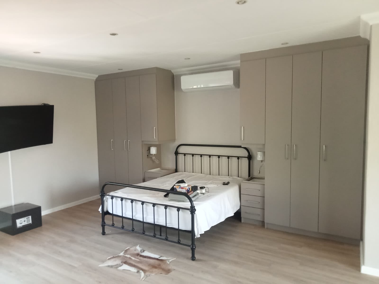 Floor to ceiling built-in bedroom cupboards in a soft grey finish with matching bedside drawers, Nelspruit