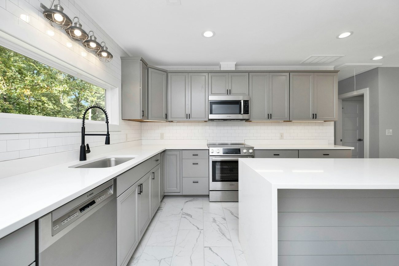 Owner-designed sage-green kitchen by Cupboard Warehouse