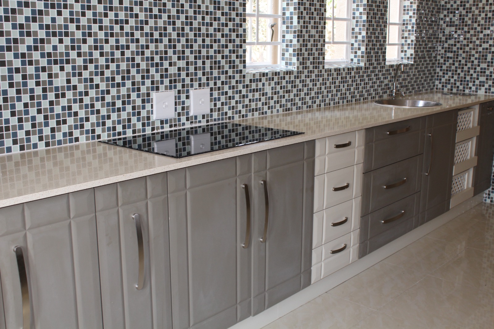 Grey high-gloss kitchen with quartz countertop