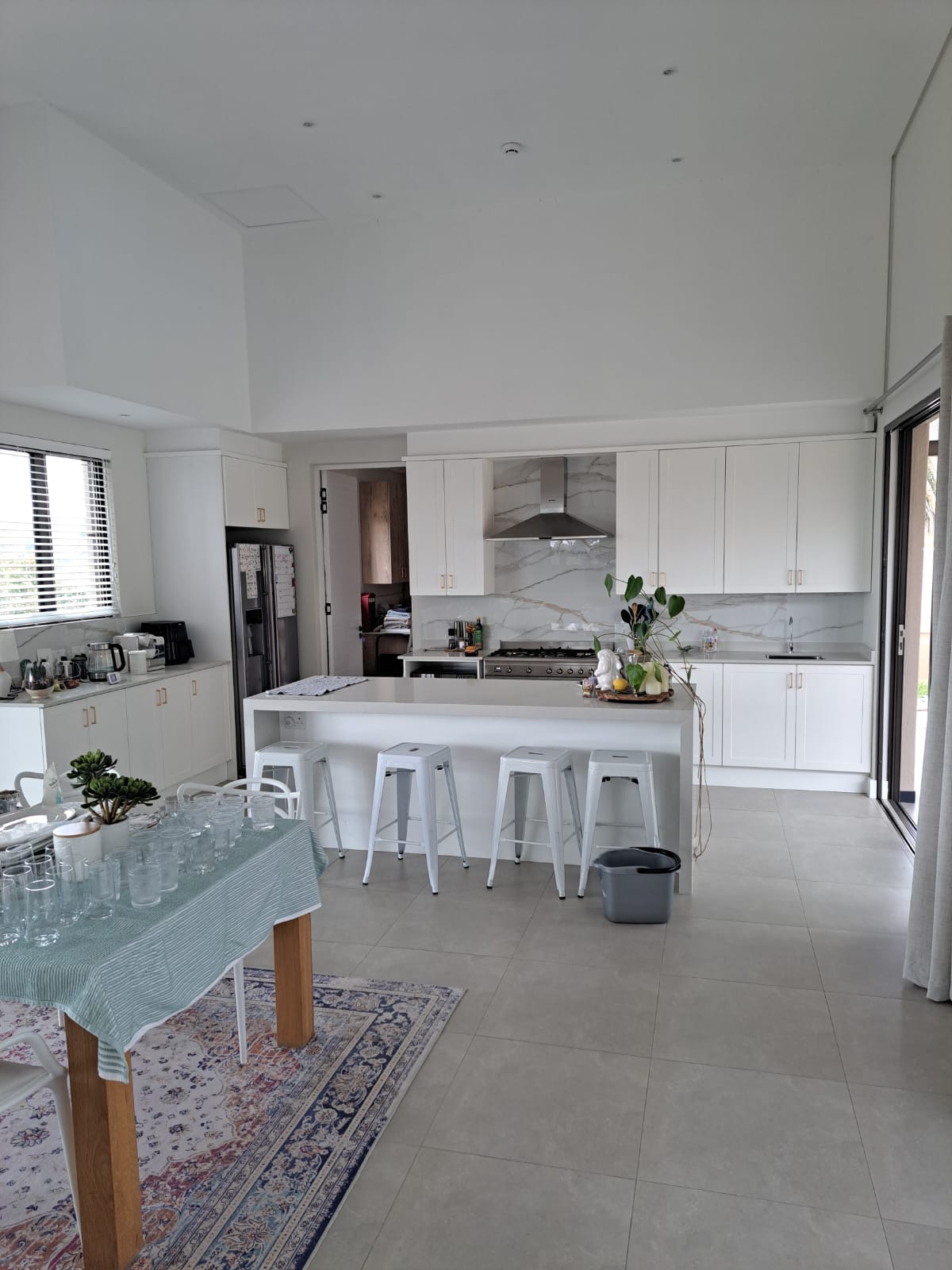 White shaker kitchen with marble splashback and large island